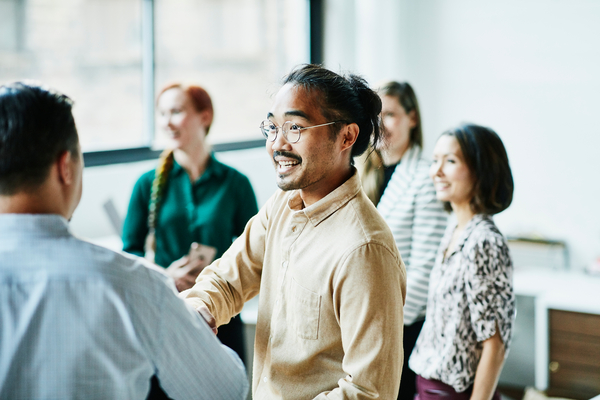  Businessman shaking hands with colleague after meeting in office