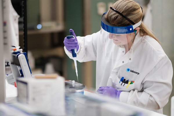 Scientist pulling a sample from a vail